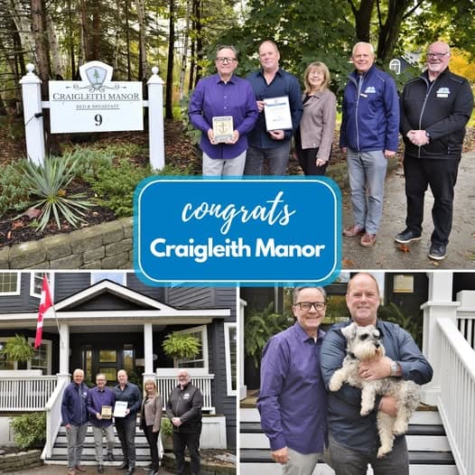 Group celebration for Craigleith Manor with awards, a dog, and a beautiful setting.