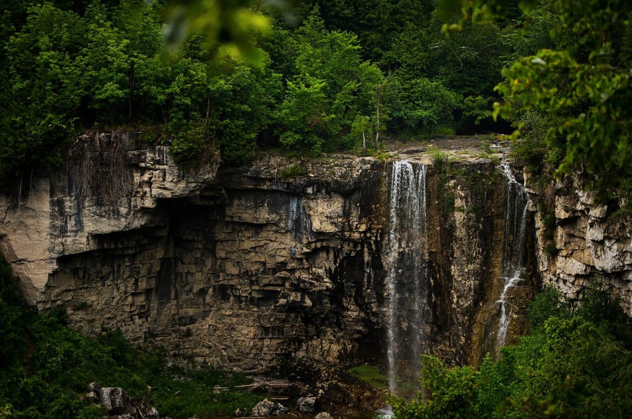 Eugenia Water Falls over rocks with trees in background