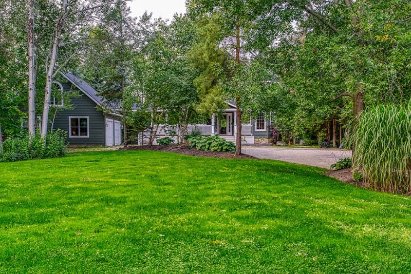 Green grass front yard with view of manor house in distance