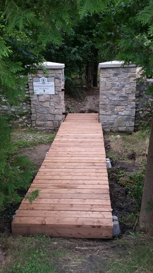 Wood foot bridge and pillars of entrance to georgian trail