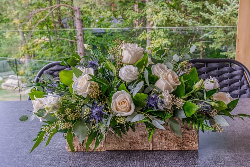 Up close view of flower centerpiece with white and purple flowers