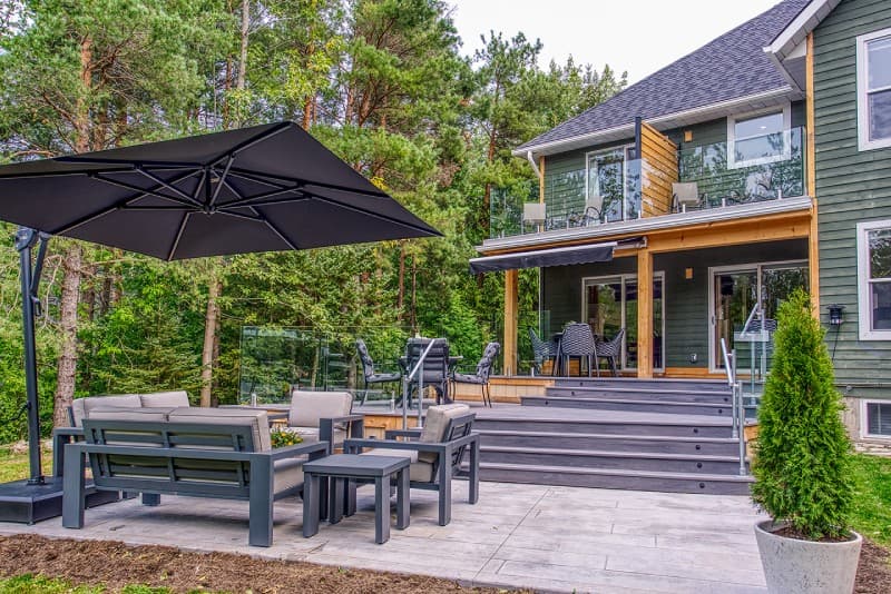 Full view of deck and patio furniture with Manor house in background